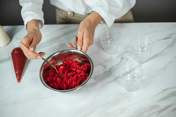 Process of creating red velvet trifle. Confectioner at work