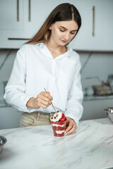 Portrait of confectioner woman with cake made by her hands