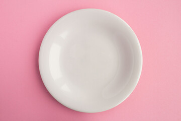 Empty white plate for text on the pink background. Copy space. Top view.