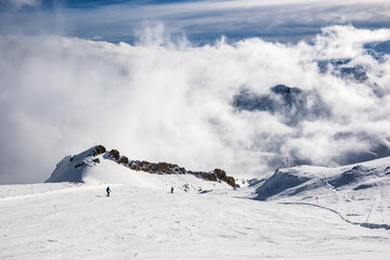 Skiers skiing in a winter mountain resort