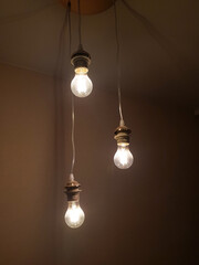 Three hanging yellow light bulbs