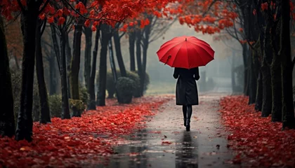 Fotobehang Fashionable woman with red umbrella in the rain, perfect copy space for your message or design © Ilja