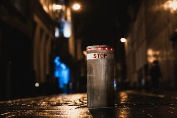 Night shot of a retractable bollard in in a city street