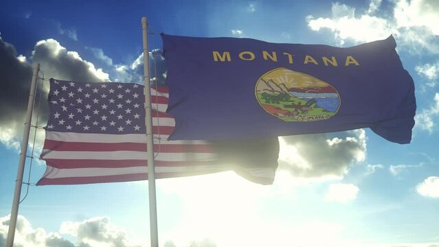 The Montana state flags waving along with the national flag of the United States of America. In the background there is a clear sky