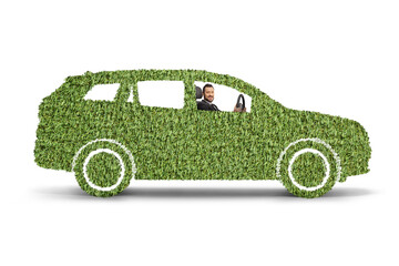 Man driving a green electric vehicle made of grass