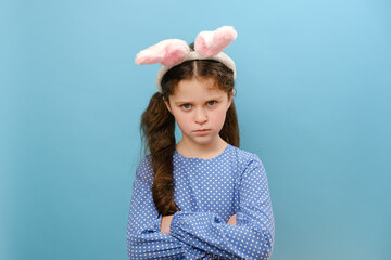 Portrait of upset preteen caucasian girl kid wearing pink fluffy easter bunny ears, angry sad...