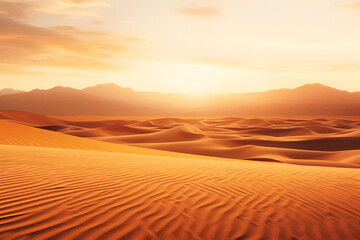Fototapeta na wymiar Golden sand ripples at sunset. The sun sets behind the orange sandy mountains, creating an atmosphere of peace, background with copy space