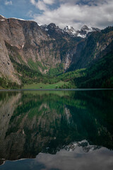 Fototapeta na wymiar Steep mountain cliffs at lake Obersee reflecting on water surface, Berchtesgaden Bavaria.