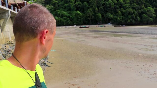 Man takes selfe photo tropical paradise beach Ao Nang Krabi Thailand.
