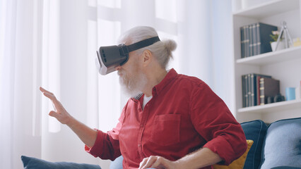 A man in his 60s explores new realms through virtual reality with a special VR glasses headset