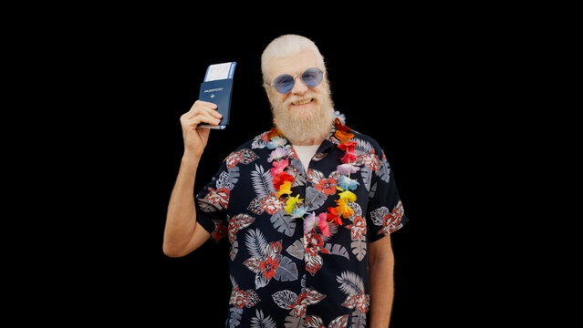 Senior man in a Hawaiian shirt displays his passport and airplane ticket, the image of a happy tourist