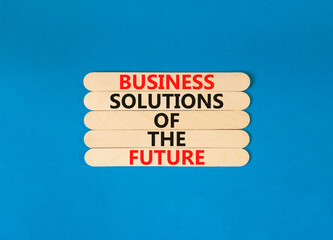 Business solutions of the future symbol. Concept words Business solutions of the future on wooden stick. Beautiful blue table blue background. Business solutions of the future concept. Copy space.