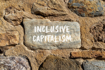 Inclusive capitalism symbol. Concept words Inclusive capitalism on beautiful grey stone. Beautiful...
