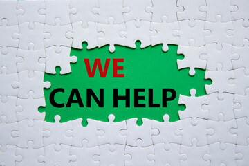 We can help symbol. Concept words We can help on white puzzle. Beautiful green background. Business and We can help concept. Copy space.