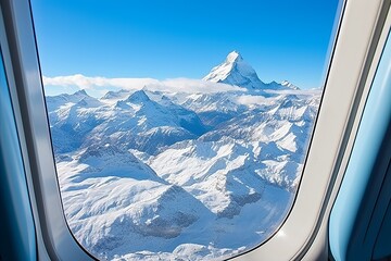 Awe-inspiring panorama of snowy mountains and clear blue sky seen through an airplane porthole