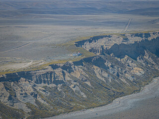 aerial view of a lighthouse far away over the mountains at the end of the world