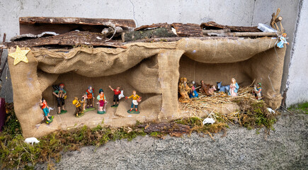 Beautiful Christmas nativity scene with holy family in a handmade wooden old stable, Italian...