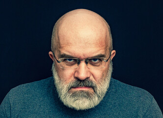 Portrait of an Angry Man with a Gray Beard