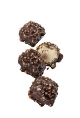 chocolate candies with nuts flying on a white background