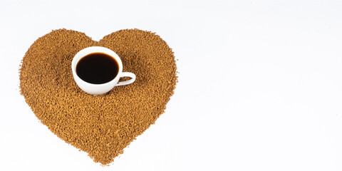 Love for coffee. Cup of instant coffee in the center of the heart of coffee granules, long banner.