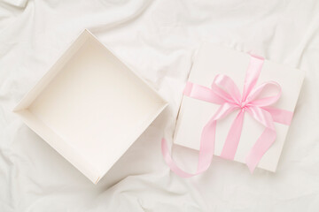 White open gift box on white sheet background, top view. Mock up for design