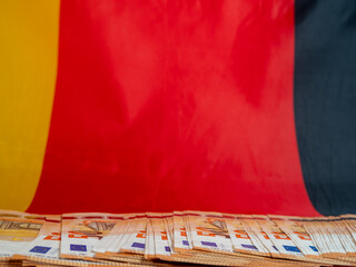 50 euro banknotes against the background of the German flag. Tax concept.