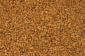 Background of freeze-dried granulated instant coffee macro close-up.