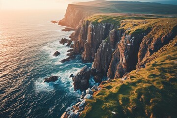 A rugged promontory rises above the sparkling sea, its grassy cliffs meeting the endless sky, a breathtaking blend of nature's power and beauty - obrazy, fototapety, plakaty
