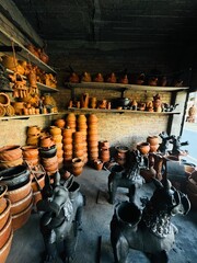 Inside a pottery workshop and shop in Kathmandu, Nepal, where various clay creations, including animals and pottery items, come to life.