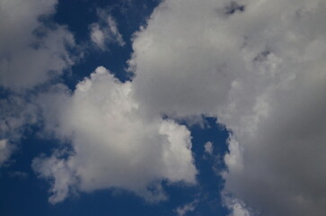 Background of rainy fluffy clouds floating on a bright blue sky, Sofia, Bulgaria   