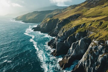 A solitary road winds along the rugged headland, leading to a secluded raised beach overlooking the vast expanse of the ocean