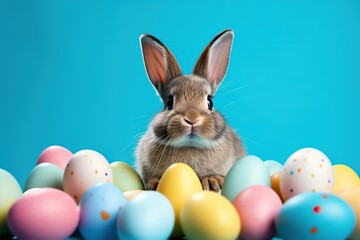 Cute bunny with easter eggs on blue background