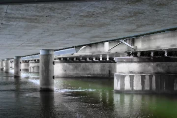 Tuinposter View of water under a bridge © niklas storm