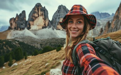 Alpine Adventure: In the Italian Alps, a smiling native woman with a backpack takes a selfie near the Dolomites, portraying the joy and cultural essence of her travel adventure.

