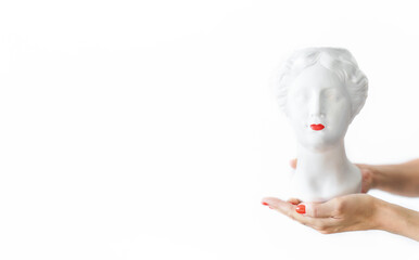 Bust of a hypothetical figure of a woman with red lips on the palm isolated on a white background