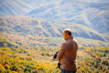 Breathtaking Mountain View: Man Enjoying Serene Landscape from Sacred Vantage Point