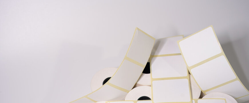  Labels for direct thermal or thermal printing. Blank sticky label roll for thermal transfer printing. Rolls of white labels isolated..
