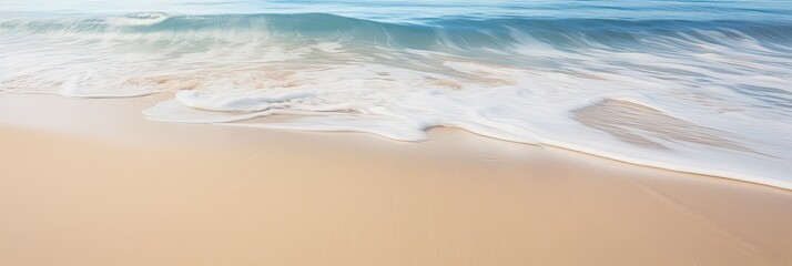 A close-up shot of gentle waves caressing the shore on a pristine sandy beach - obrazy, fototapety, plakaty
