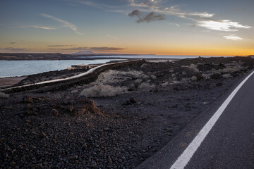 Road, lava field and a sunset, Lanzarote, Spain