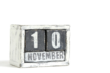 November 10 on wooden calendar, on white background.