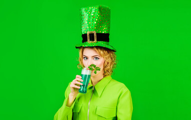 Saint Patricks day celebration. Blonde woman in leprechaun hat with glass of green beer. Patrick...