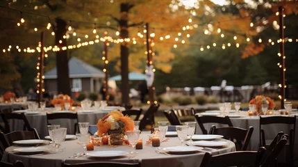 Fotobehang Autumnal outdoor wedding reception with pumpkin centerpieces, string lights, and fall-inspired decor, creating a romantic and enchanting atmosphere © KerXing