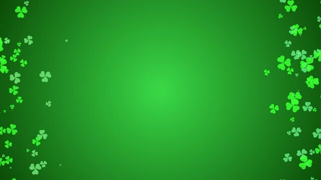 Shamrock clover leaves floating on a green background with copy space. St. Patrick's Day seamless loop background for greeting cards and banners
