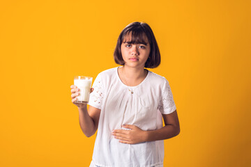 Girl with glass of milk feeling stomach pain. Dairy Intolerant person. Lactose intolerance, health...