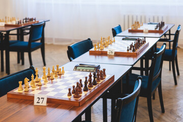 Chess tournament, kids and adults participate in chess match game outdoors in indoor hall, players...