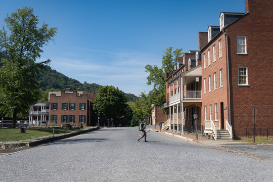 Harpers Ferry, West Virginia: Appalachian Trail hiker crosses Shenandoah Street near John Brown's Fort. AT crosses through Harpers Ferry National Historic Park. 