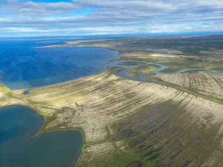 Aerial view of Lake Iliamna with islands, Aleutian mountain range and reflection. Near Pedro Bay,...