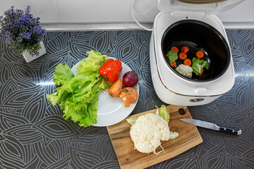 Cooking food in multi cooker close up. Organic food. Food preparation. Top view. Background.