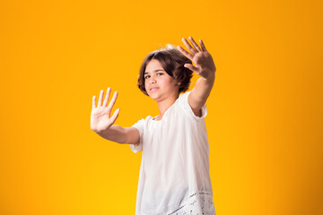 Kid girl afraid and terrified with fear expression stop gesture with hands