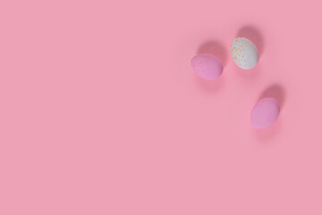 Minimalistic easter background of chocolate candy pink and white eggs on pink background. Top view with free copy space for text